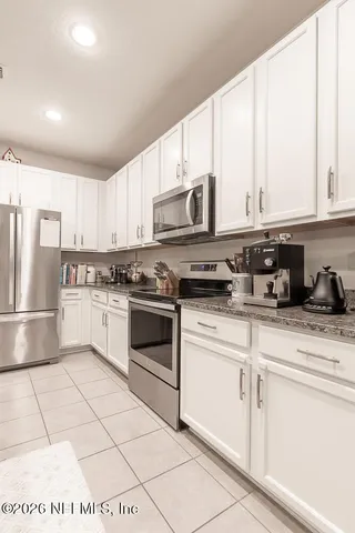 a kitchen with a table chairs and microwave