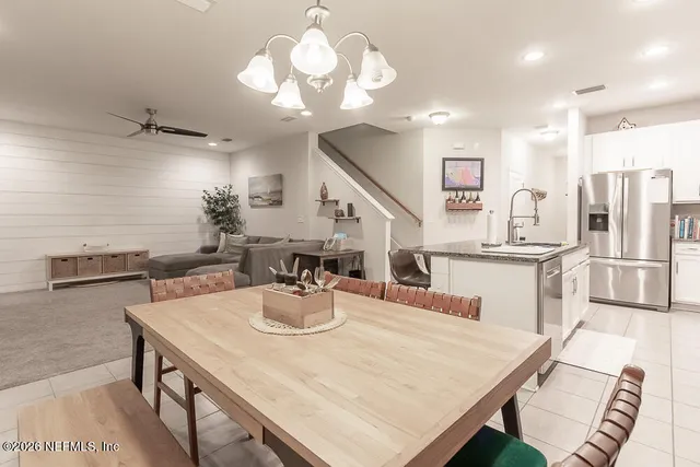 a kitchen with stainless steel appliances granite countertop white cabinets a sink and dishwasher