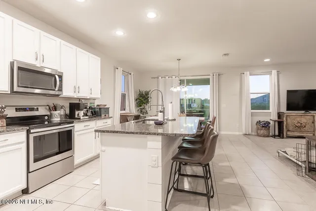 a view of a livingroom with furniture and a window