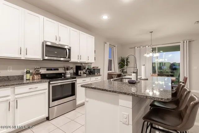 a bathroom with a granite countertop sink mirror and toilet