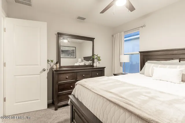 a bedroom with a bed and a large mirror