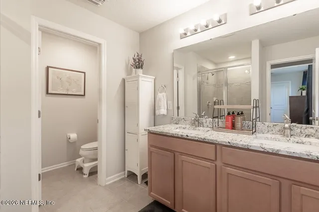 a bedroom with a large bed and a potted plant