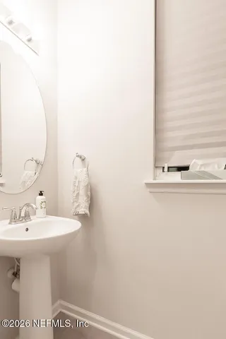 a bathroom with a sink a mirror and vanity