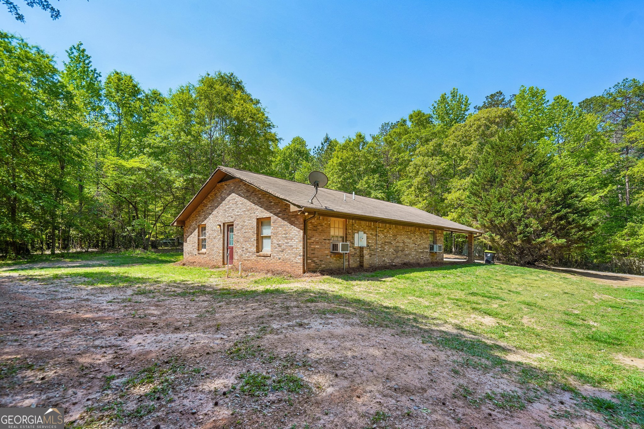 241 Busbin Road Fayetteville, GA 30215 - Photo 28 of 45 a big house with a big yard and large trees
