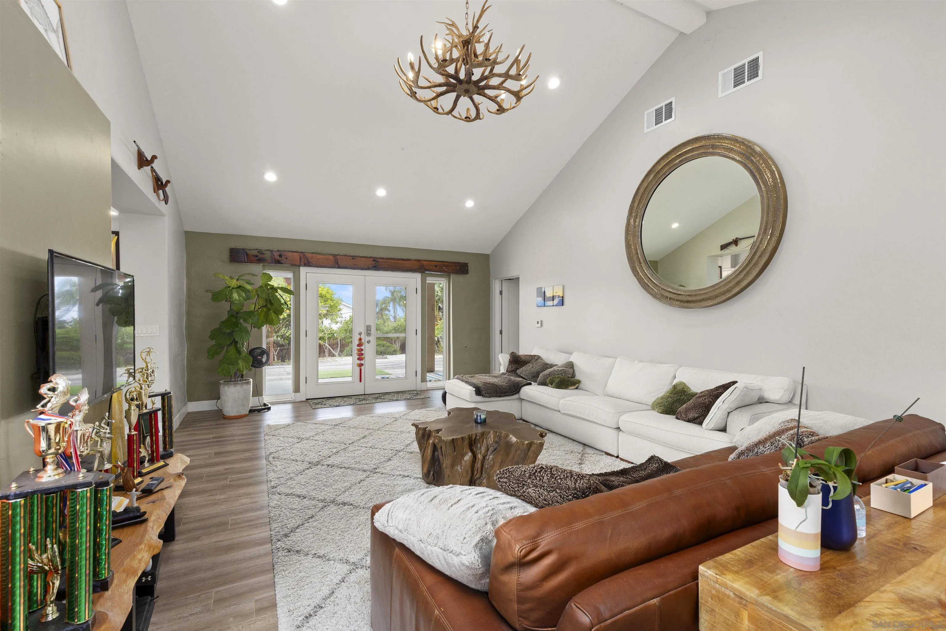752 Bracero Road Encinitas, CA 92024 - Photo 13 of 46 a living room with furniture a window and a flat screen tv