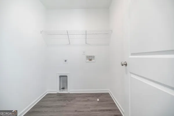 a view of a room with wooden floor