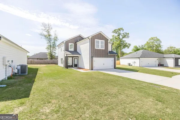 a front view of a house with a yard and garage
