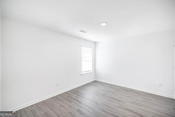 a view of an empty room and wooden floor