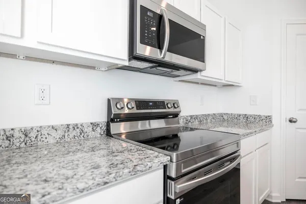 a kitchen with a stove and a microwave