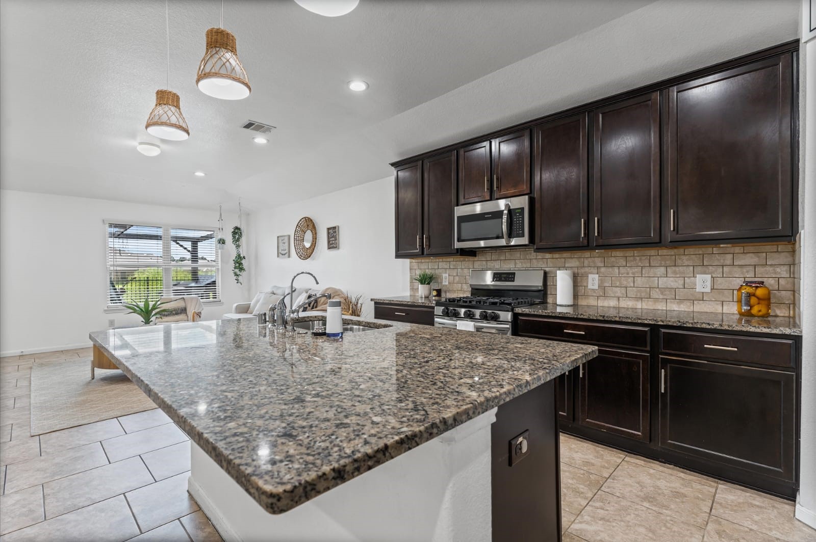 3007 Magellan Ridge Lane Baytown, TX 77521 - Photo 15 of 34 a kitchen with kitchen island granite countertop stainless steel appliances a sink a stove cabinets counter space and a window