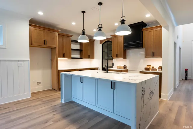 a view of a kitchen with a sink and refrigerator