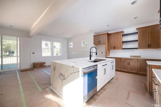 a kitchen with cabinets appliances and a counter space