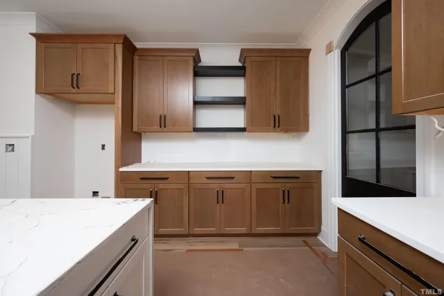 a kitchen that has a sink and a stove in it