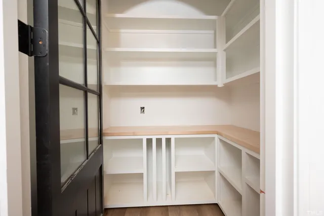 a view of an empty room with a fireplace and a window