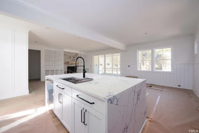 a view of an empty room with a fireplace and a window