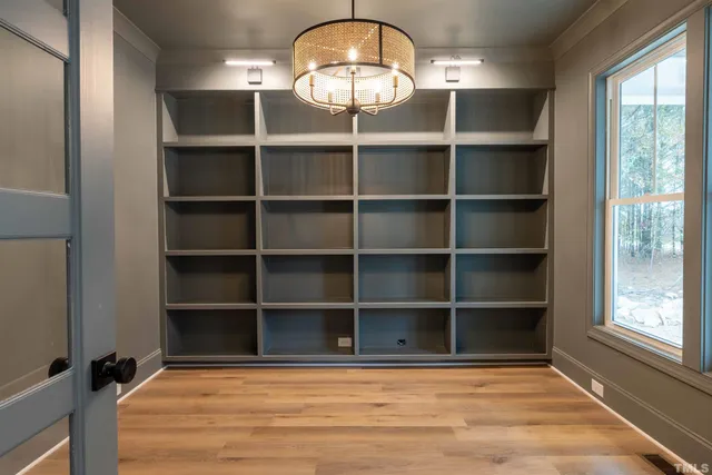 a view of a room with wooden floor and a window