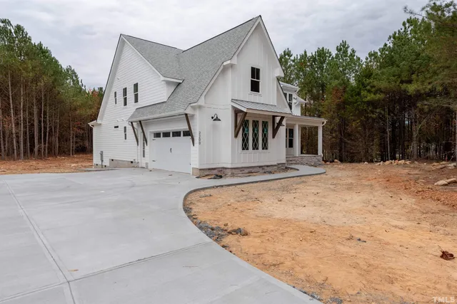 a view of a house with yard and sitting area