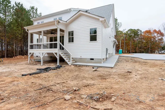 a view of backyard with balcony and wooden floor