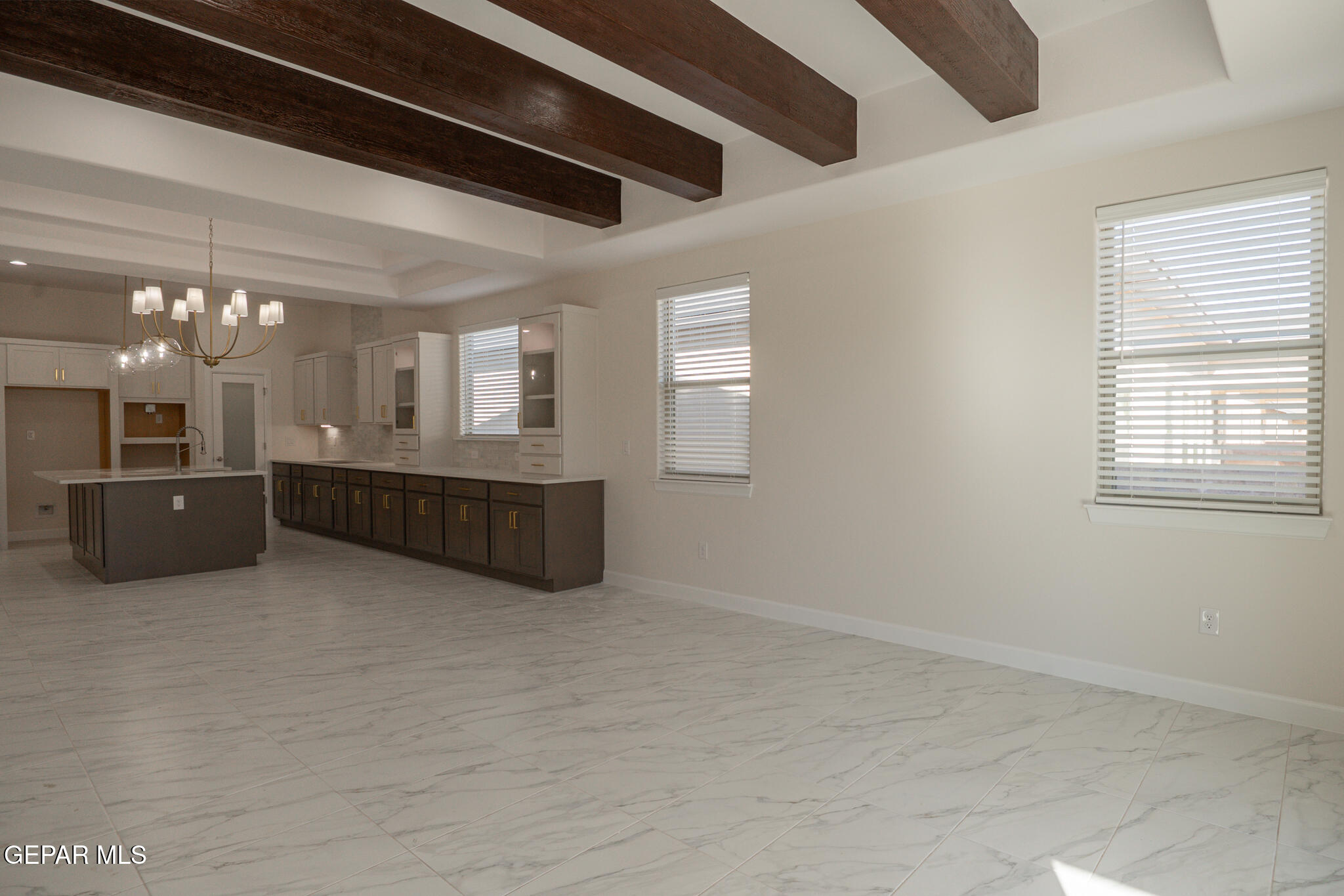 3769 Course Street El Paso, TX 79938 - Photo 13 of 34 a large room with chandelier and a kitchen