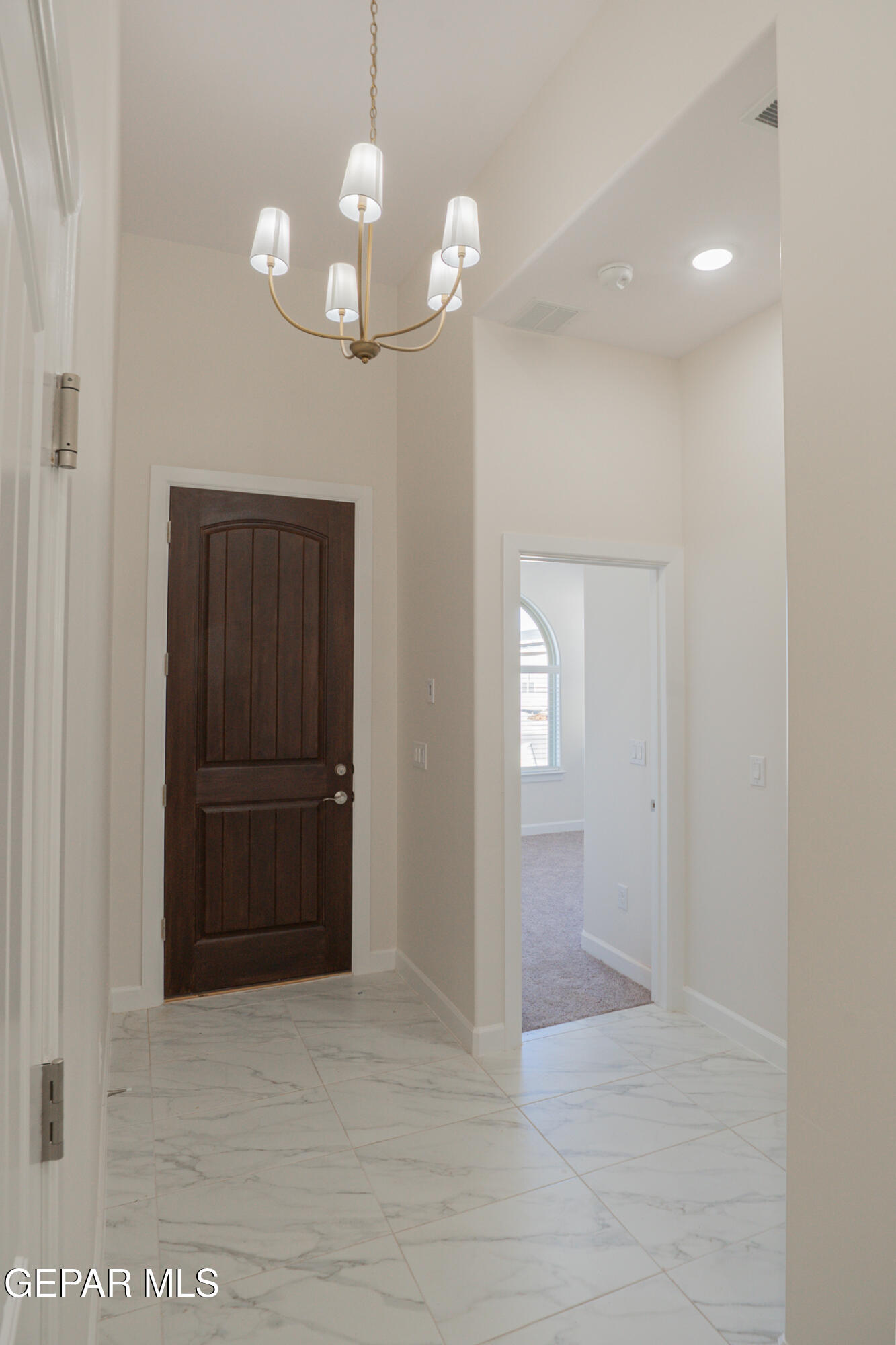 3769 Course Street El Paso, TX 79938 - Photo 2 of 34 a view of a hallway with wooden floor and chandelier