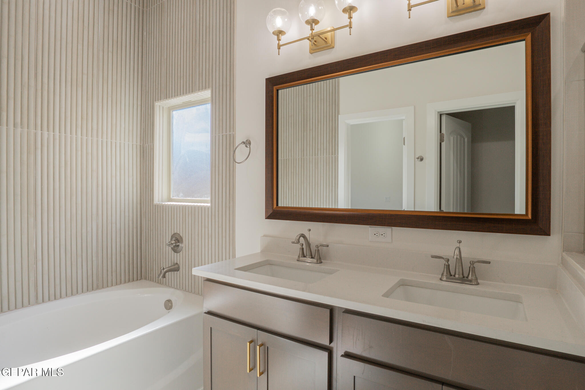 3769 Course Street El Paso, TX 79938 - Photo 21 of 34 a bathroom with a granite countertop sink mirror and a bathtub