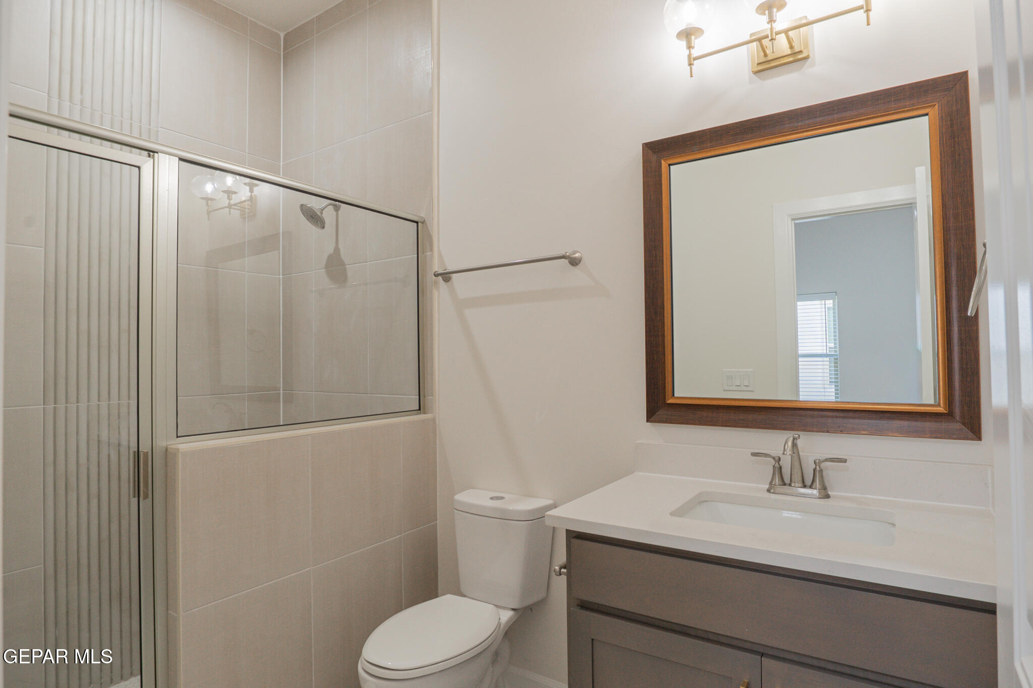 3769 Course Street El Paso, TX 79938 - Photo 4 of 34 a bathroom with a granite countertop sink toilet and shower