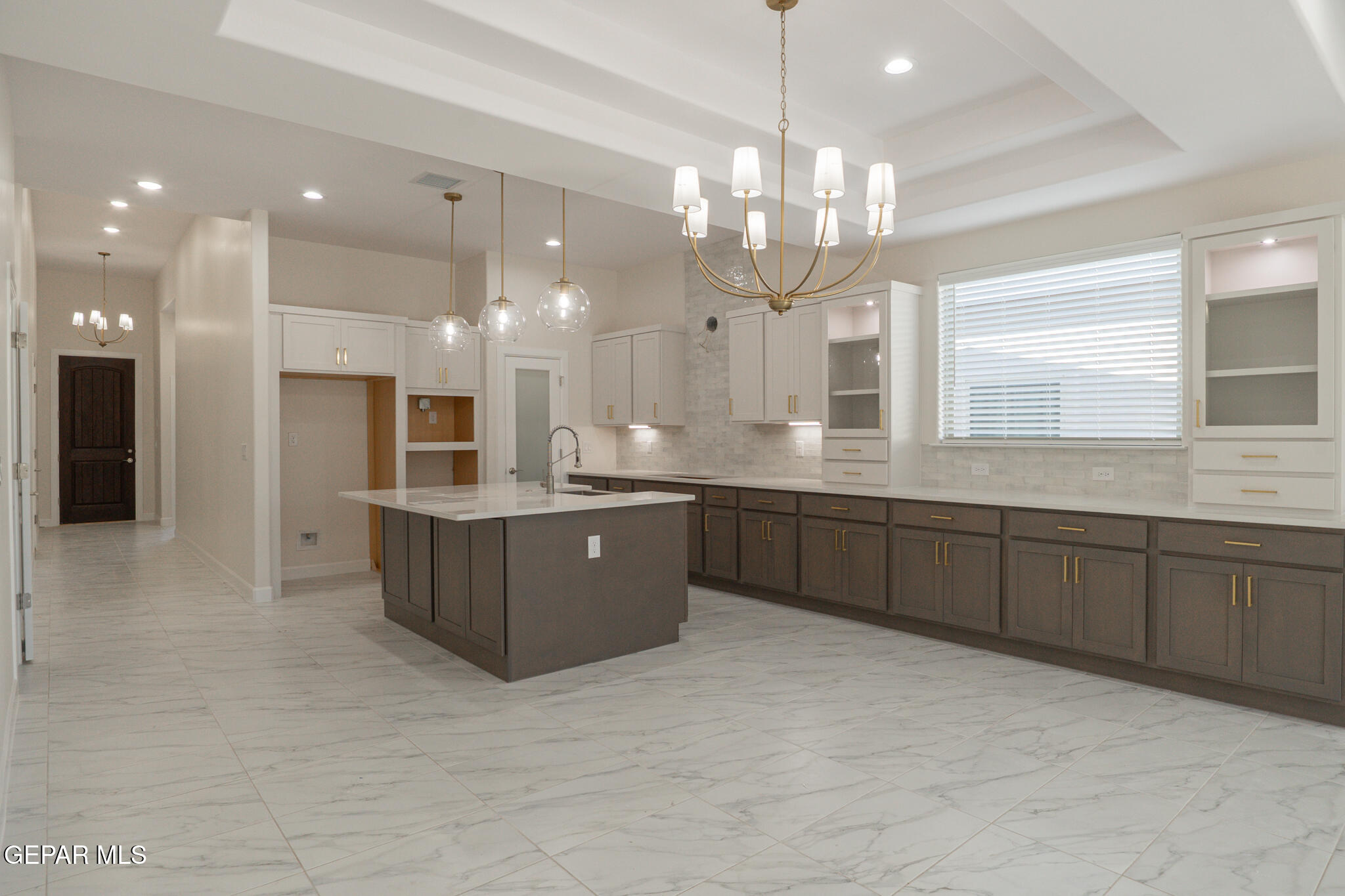 3769 Course Street El Paso, TX 79938 - Photo 7 of 34 a large kitchen with a large island in it