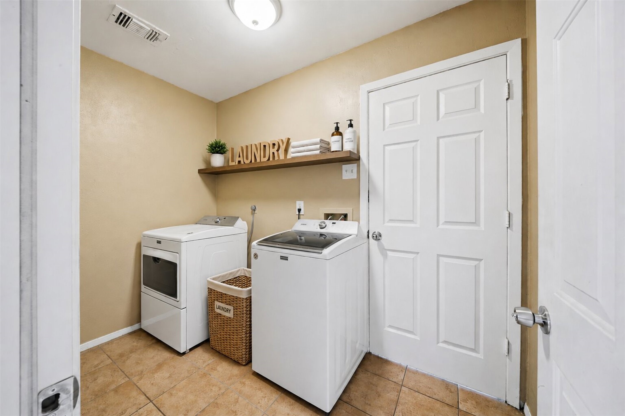 9418 Kilrenny Drive Spring, TX 77379 - Photo 19 of 47 a view of washer and dryer with kitchen in the background