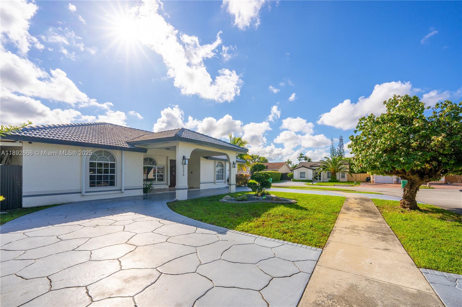 2275 Southwest 143rd Court Miami, FL 33175 - Photo 15 of 64 a front view of a house with garden