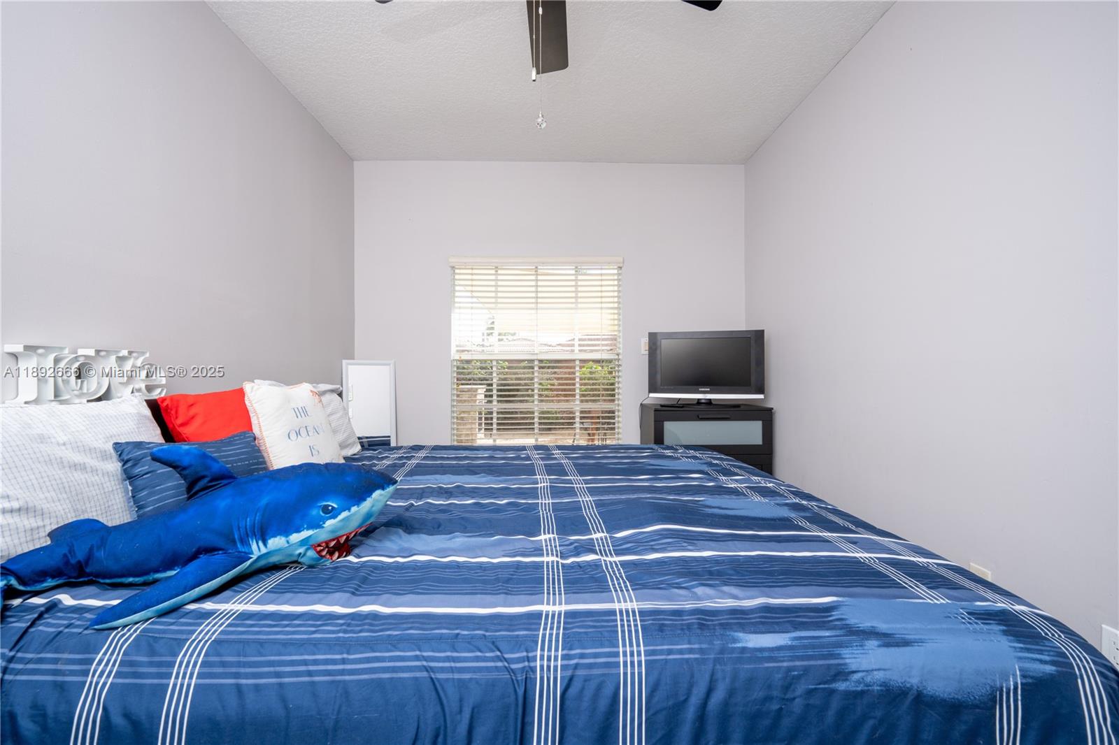 2275 Southwest 143rd Court Miami, FL 33175 - Photo 19 of 64 a living room with a couch and a flat screen tv