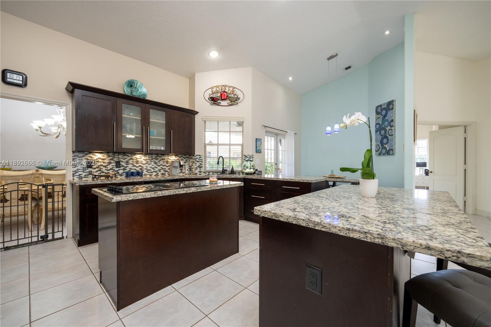 2275 Southwest 143rd Court Miami, FL 33175 - Photo 2 of 64 a kitchen with stainless steel appliances kitchen island granite countertop a stove and cabinets