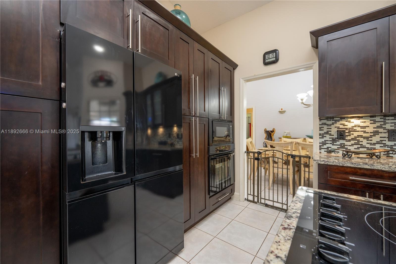 2275 Southwest 143rd Court Miami, FL 33175 - Photo 28 of 64 a kitchen with granite countertop a refrigerator and a stove