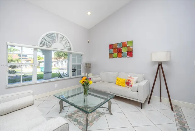 a large bedroom with a bed and a flat screen tv