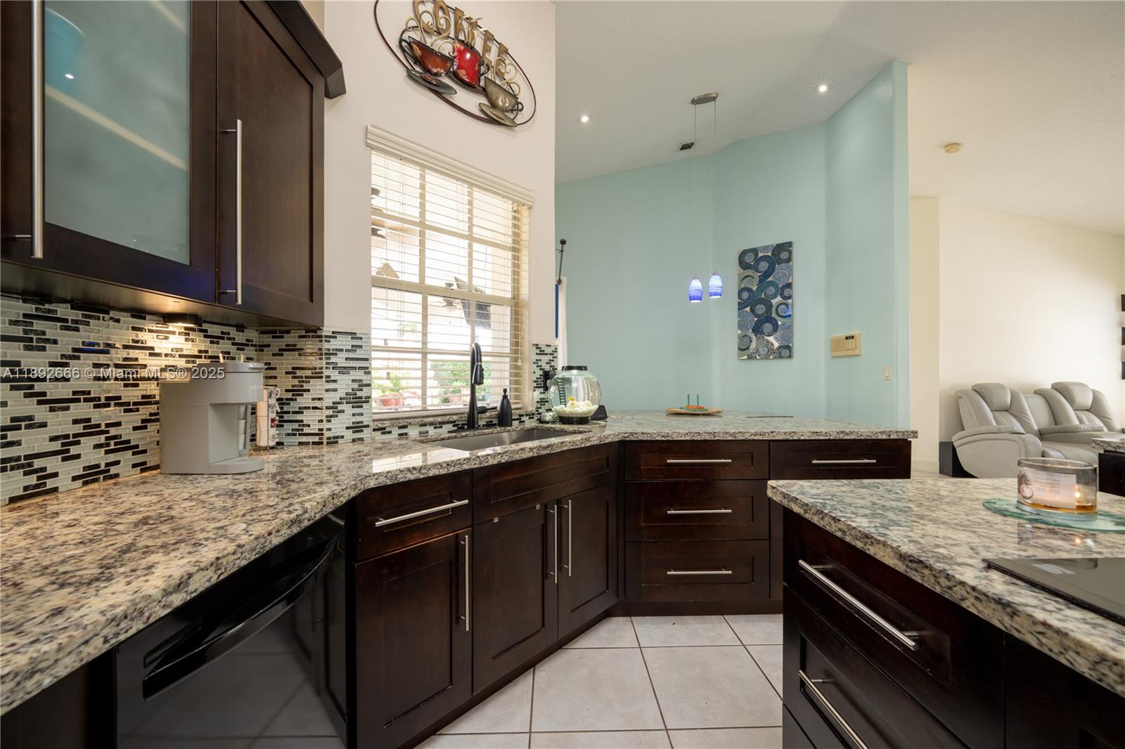 2275 Southwest 143rd Court Miami, FL 33175 - Photo 30 of 64 a kitchen with granite countertop stainless steel appliances sink and window