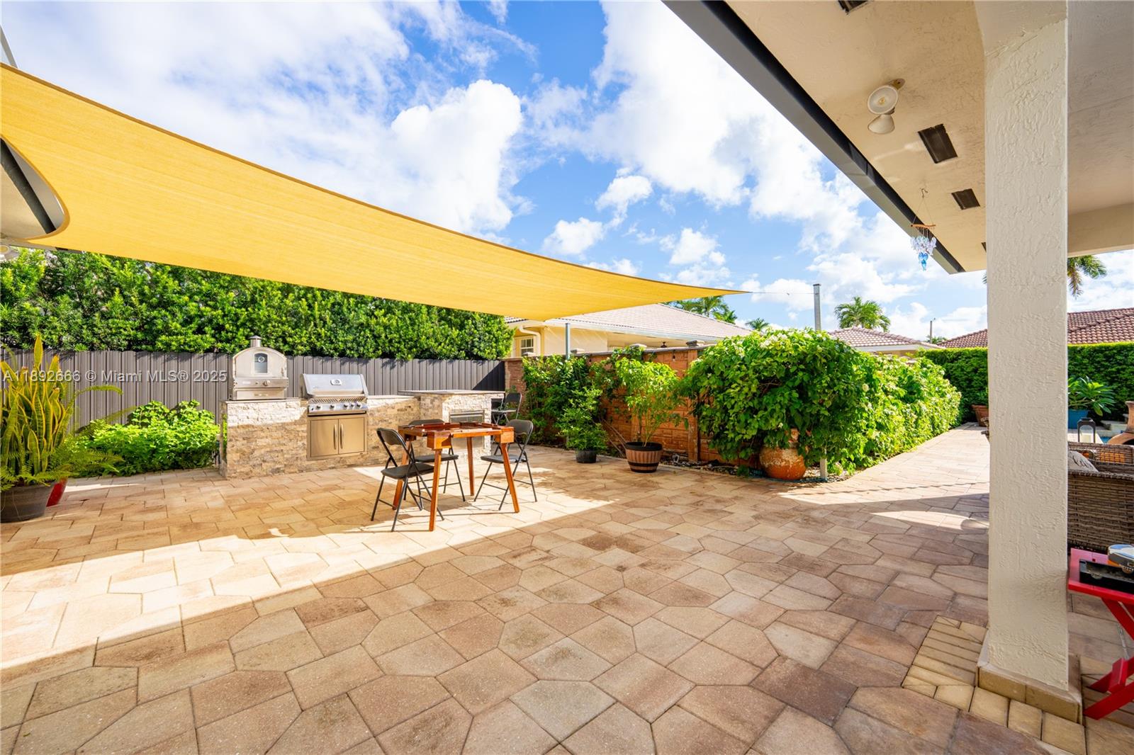 2275 Southwest 143rd Court Miami, FL 33175 - Photo 34 of 64 a view of a patio with a table and chairs under an umbrella