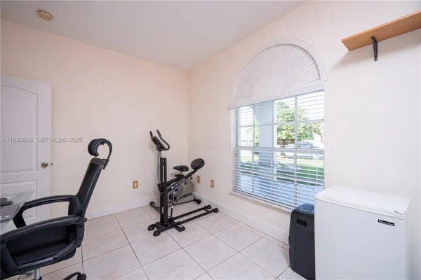 a view of a patio with a table and chairs and potted plants