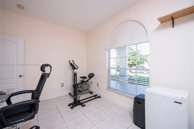 a view of a patio with a table and chairs and potted plants