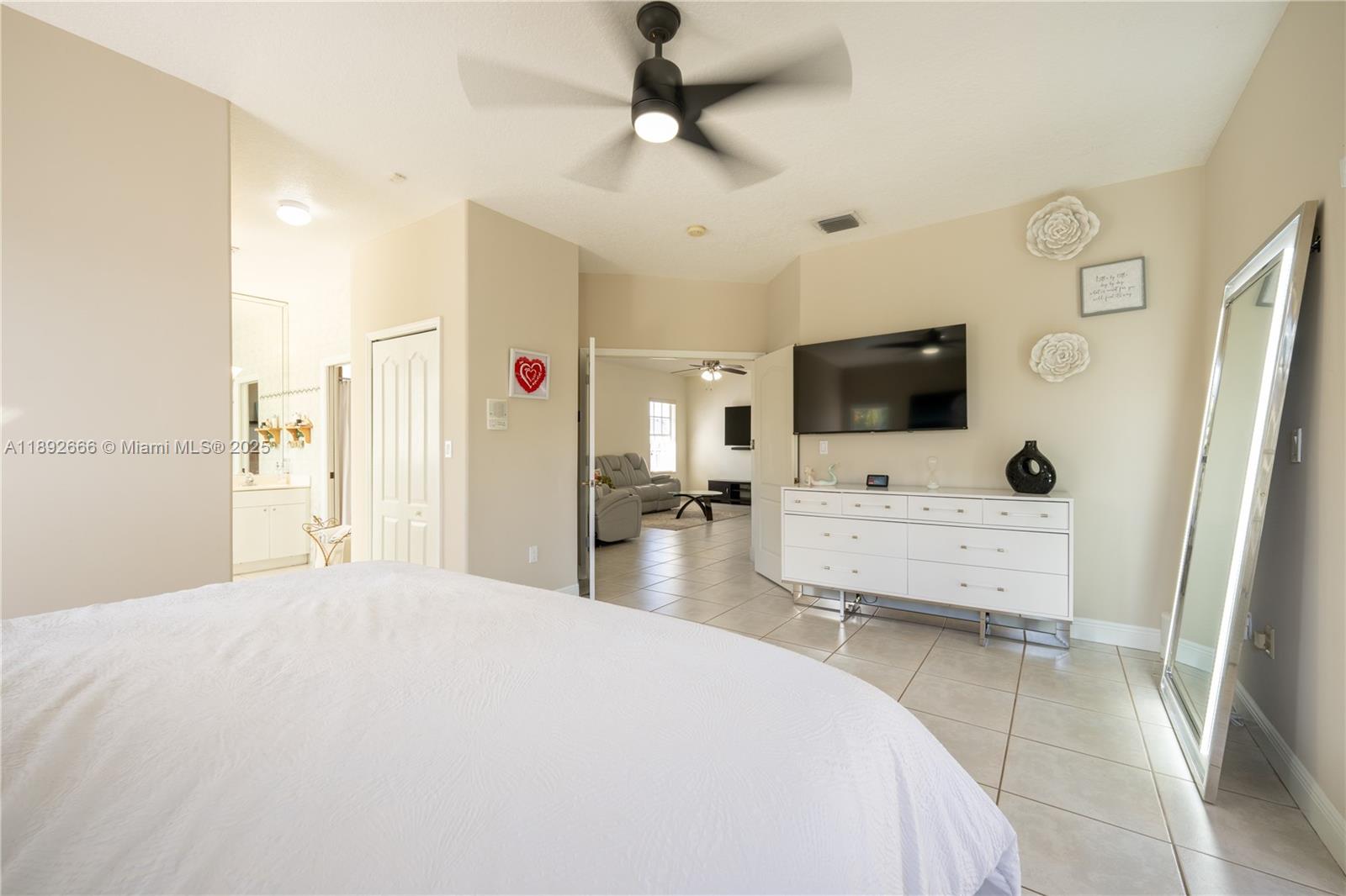 2275 Southwest 143rd Court Miami, FL 33175 - Photo 37 of 64 a large bedroom with a bed and a flat screen tv