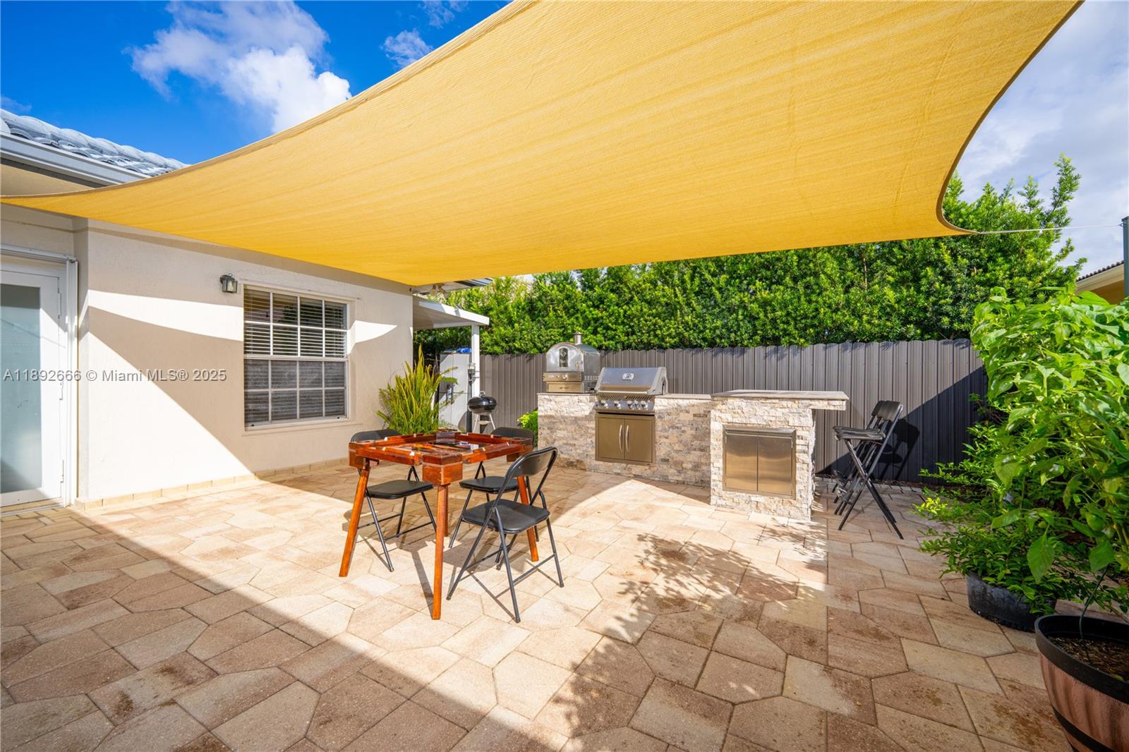 2275 Southwest 143rd Court Miami, FL 33175 - Photo 45 of 64 a view of a patio with a table and chairs and potted plants