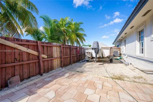 an aerial view of a house with a yard and potted plants