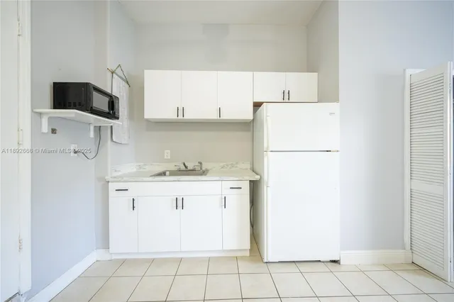 an aerial view of residential houses with outdoor space and swimming pool
