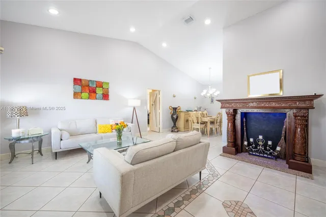 a kitchen with a refrigerator a sink a dining table and chairs