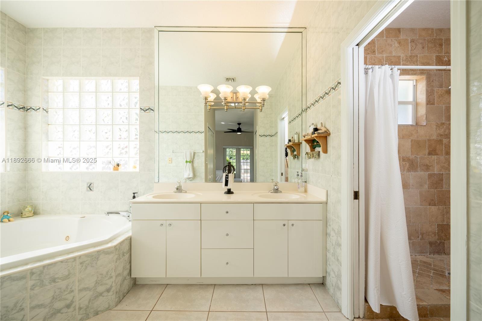2275 Southwest 143rd Court Miami, FL 33175 - Photo 9 of 64 a bathroom with a bathtub sink and mirror