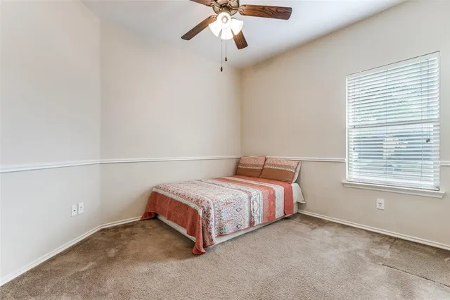a living room with furniture and a gym cycle