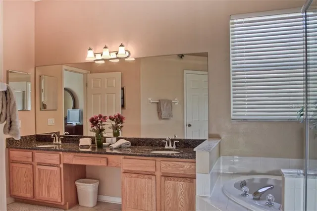 a bathroom with a double vanity sink and a mirror