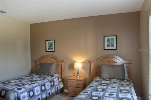 a bedroom with a bed and a lamp