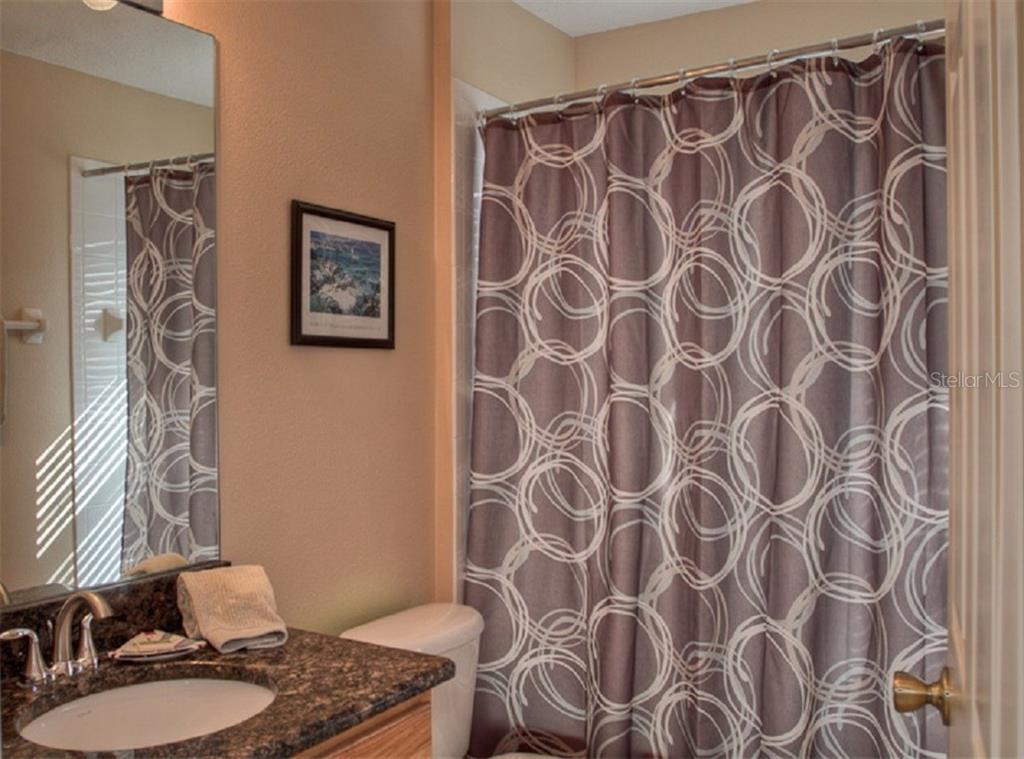 4418 Useppa Drive Bradenton, FL 34203 - Photo 15 of 22 a bathroom with a shower curtain and a sink