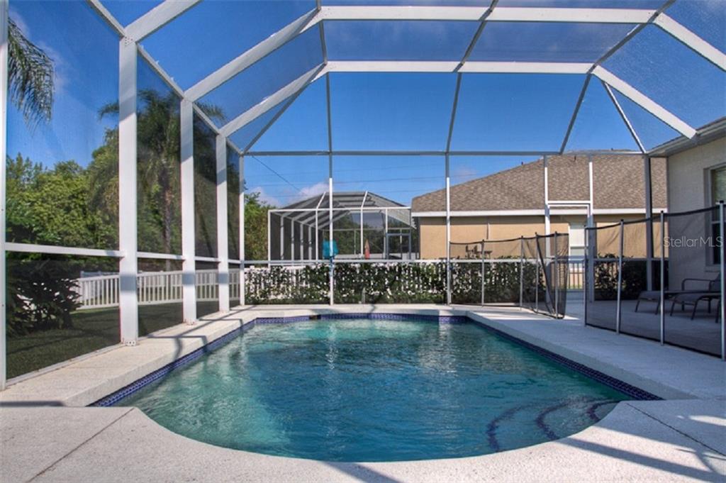 4418 Useppa Drive Bradenton, FL 34203 - Photo 18 of 22 a view of a house with backyard and porch