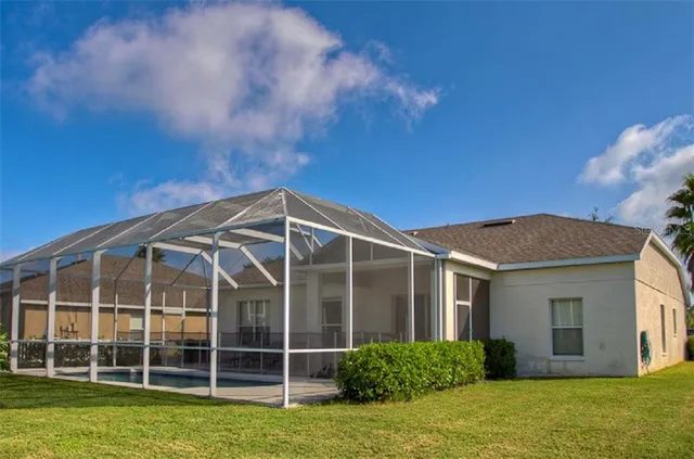 a view of a house with a yard and potted plants