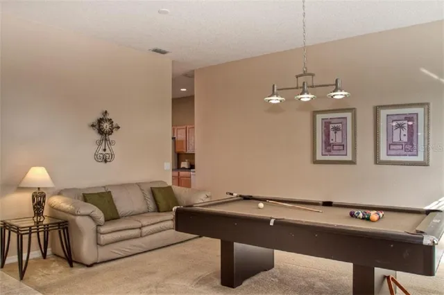 a living room with a couch and chandelier